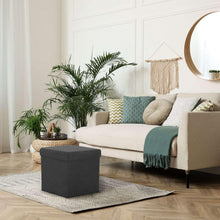 Foldable ottoman cube in dark gray fabric with cushioned top