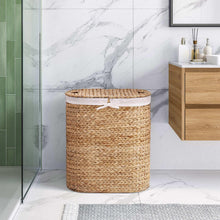 Handwoven water hyacinth laundry hamper with round woven body and removable white-lined top
