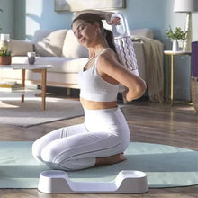 Rolling massager used on a leg while seated; ribbed rollers on the device