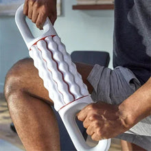 Rolling massager applying ribbed rollers to a lower leg on a seated person