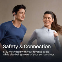 Black open-ear true wireless earbuds worn in ears by a person