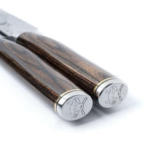 Two steak knives showing dark wood handles with metal end caps