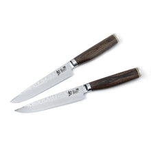 Two steak knives with engraved stainless blades and dark wood handles