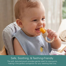 Baby tasting tan silicone fruit feeder with beaded handle and pouch