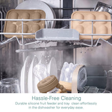 Tan silicone fruit feeders and freezer tray in dishwasher rack with water spray