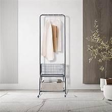 Black rolling garment rack with wheels and hanging clothes, with lower shelf