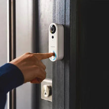 Wired video doorbell mounted on door frame; hand touching the blue light ring