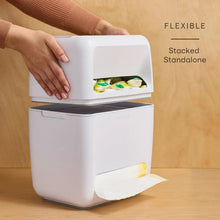 White stacked pod-and-trash organizer with hand lifting a bag from the front opening