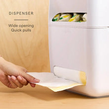 White under-sink pod and trash bag organizer dispensing a bag through the front slot