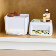 White under-sink organizer pair: pod tray unit and trash bag dispenser with bottles and sponge