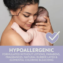 Baby being held with a white diaper featuring a subtle print