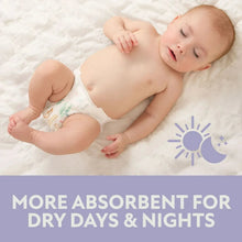 Baby lying on a bed wearing a white diaper with a small print