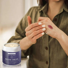 Arnica bruise cream being applied on hands; jar container beside.
