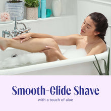 Women’s disposable razor gliding on legs during shower