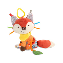 Fox plush stroller toy with orange tail, yellow bib, striped legs and teether leaf