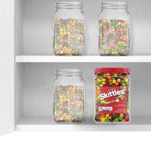 Skittles candy jar on shelf with mixed fruit-flavored candies