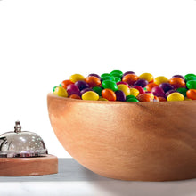 Wood bowl filled with colorful bite-size candies, viewed close-up.