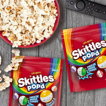 Freeze-dried candy resealable bags with Skittles Pop'd branding on wood surface