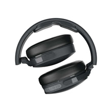 Black over-ear headphones, top view showing headband and earcup buttons