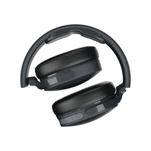 Over-ear wireless headphones showing headband and two cushioned earcups, dark finish