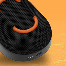 Skullcandy mini wireless speaker with orange handle, textured grille, dark black