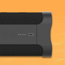 Black rugged wireless speaker side with buttons and charging port
