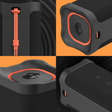 Black rugged wireless speaker with orange strap and top control panel detail
