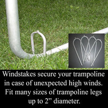 Trampoline wind stakes anchored in grass, U-shaped galvanized ground pegs
