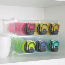 Clear stackable bottle organizer with colored bottle holders, two-tier shelf tray