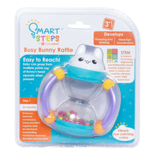 Busy bunny rattle in blister pack, pale white bunny head, blue and purple frame