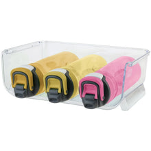 Clear stackable bottle organizer with pink, yellow, and green bottle holders, angled view
