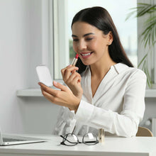 LED double-sided compact mirror in use, person holding mirror and lipstick