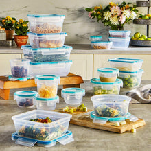 Clear plastic food storage containers with blue lids, various sizes on countertop