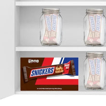 Chocolate candy bar gift set with Snickers box and clear jar packs on shelf
