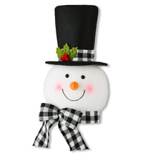 Snowman Christmas tree topper with black hat, white face, plaid scarf and bow