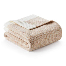 Heather beige knitted throw blanket, folded with textured surface and cream stripe detail.