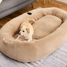 Beige round plush dog bed with hollow center and black paw-print opening