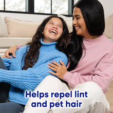 Two people on couch holding blue knit sweater; lint-repelling claim shown.