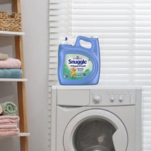 Snuggle SuperFresh liquid fabric conditioner bottle next to front-load washing machine