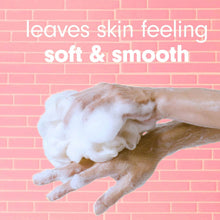 Softsoap exfoliating body wash lather on a hand with "soft & smooth" text