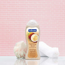 Softsoap exfoliating body wash bottle with coconut butter scrub on a white towel