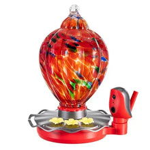 Glass hummingbird feeder bulb with red base, bird figurine, and flower tray