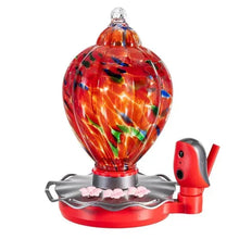 Solar hummingbird feeder with glass bulb, red bird base, and pink flower accents