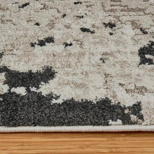 Runner rug pile and border close-up with speckled light gray and dark charcoal texture