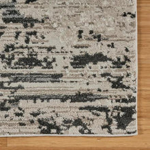 Runner rug close-up with abstract distressed blocks in light gray and dark charcoal
