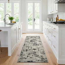 Runner rug with distressed abstract pattern in light gray and dark charcoal