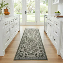 Ornate sage runner rug with distressed geometric pattern
