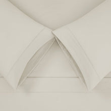 Microfiber sheet set corner detail with soft white fabric and stitched folds