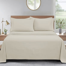 Microfiber sheet set with solid beige design, flat sheet and pillowcases on a bed