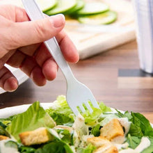 White plastic fork held in a hand above salad